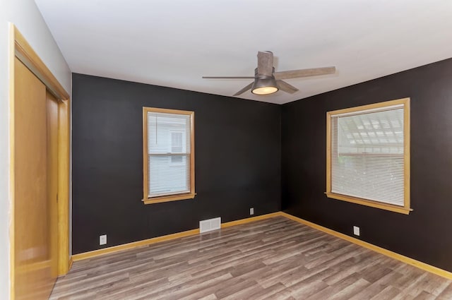 1617 Oakland Ave, Crest Hill, IL 60403 - unfurnished bedroom with wood finished floors, a closet, and ceiling fan