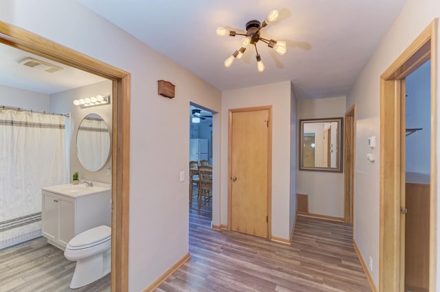 1617 Oakland Ave, Crest Hill, IL 60403 - hall featuring wood finished floors and baseboard heating