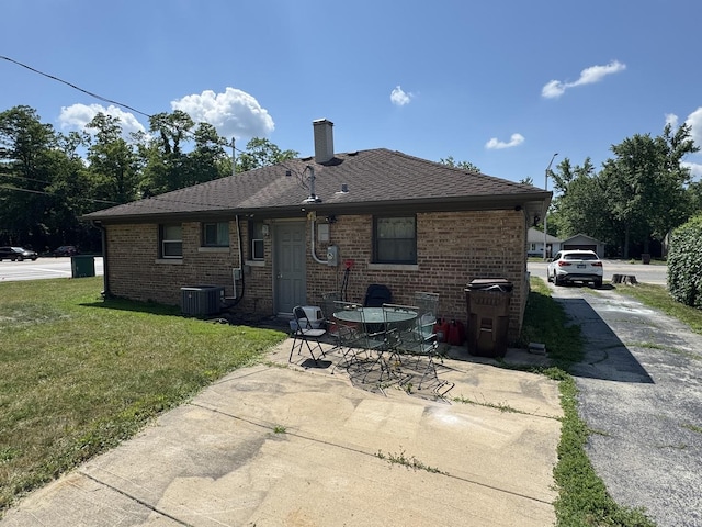 2 Sauk Trl, Park Forest, IL 60466 - back of property featuring a lawn, a patio area, a chimney, and brick siding