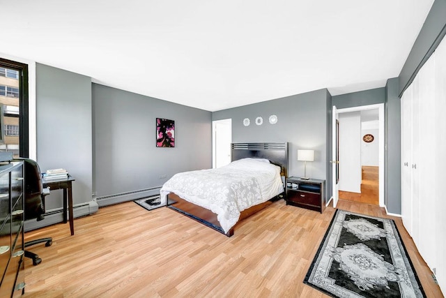 6325 N Sheridan Rd Unit 1903, Chicago, IL 60660 - bedroom featuring a baseboard heating unit, light wood finished floors, a closet, and an office area
