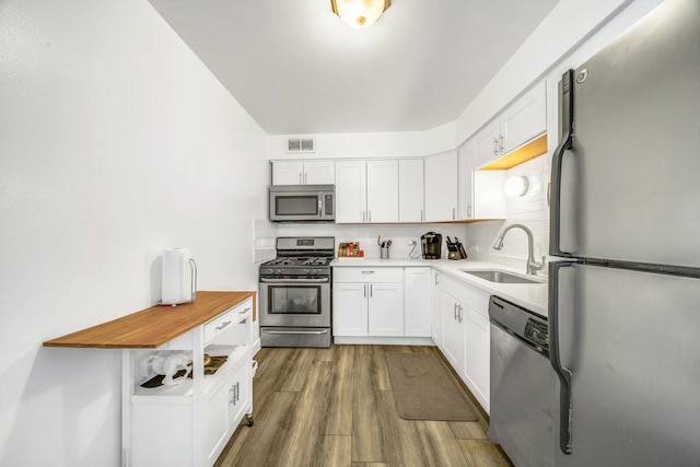 6325 N Sheridan Rd Unit 1903, Chicago, IL 60660 - kitchen with appliances with stainless steel finishes, wood finished floors, and white cabinets