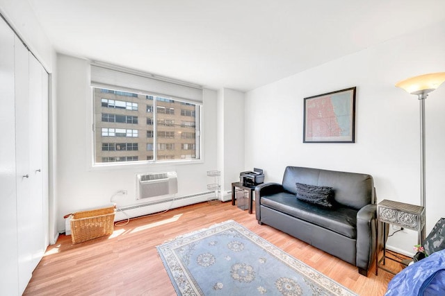 6325 N Sheridan Rd Unit 1903, Chicago, IL 60660 - sitting room with a baseboard radiator, an AC wall unit, and wood finished floors
