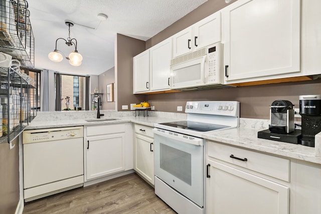 222 N Columbus Dr Unit 2204, Chicago, IL 60601 - kitchen with white appliances, light wood-type flooring, white cabinets, hanging light fixtures, and light stone counters