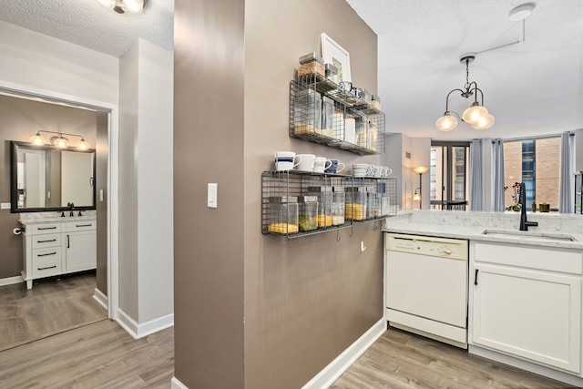 222 N Columbus Dr Unit 2204, Chicago, IL 60601 - kitchen featuring dishwasher, light wood-style flooring, white cabinets, a textured ceiling, and light stone countertops