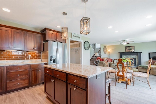 5108 Longfield Rd, Bloomington, IL 61705 - kitchen with stainless steel refrigerator with ice dispenser, light wood-type flooring, ceiling fan, decorative backsplash, and open floor plan