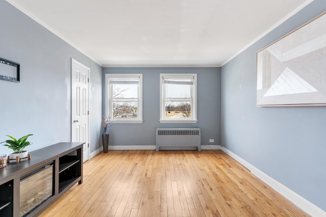 2204 S 9th Ave Unit 2, Broadview, IL 60155 - spare room with radiator, wood-type flooring, and ornamental molding