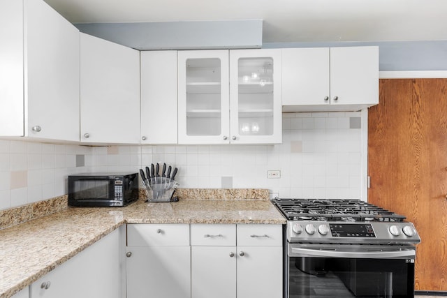 2204 S 9th Ave Unit 2, Broadview, IL 60155 - kitchen featuring gas stove, black microwave, backsplash, white cabinets, and glass insert cabinets