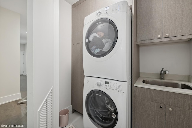 2814 W N Ave Unit 2W, Chicago, IL 60647 - laundry room with stacked washer / drying machine and cabinet space
