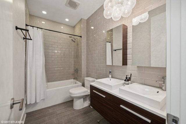 2814 W N Ave Unit 2W, Chicago, IL 60647 - bathroom featuring double vanity, shower / bath combo, tile walls, decorative backsplash, and a chandelier