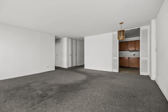 5455 N Sheridan Rd Unit 3203, Chicago, IL 60640 - unfurnished living room featuring dark colored carpet and baseboards