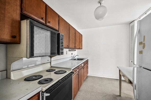 5455 N Sheridan Rd Unit 3203, Chicago, IL 60640 - kitchen featuring white appliances, light countertops, light floors, and brown cabinets