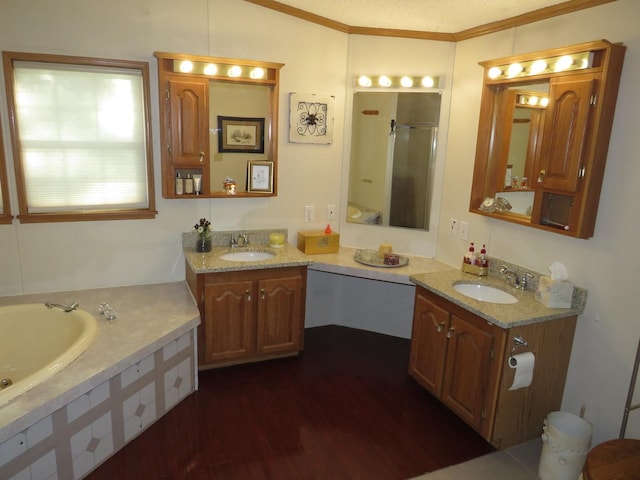 510 7th St, Mazon, IL 60444 - full bathroom with crown molding, a garden tub, a stall shower, two vanities, and wood finished floors