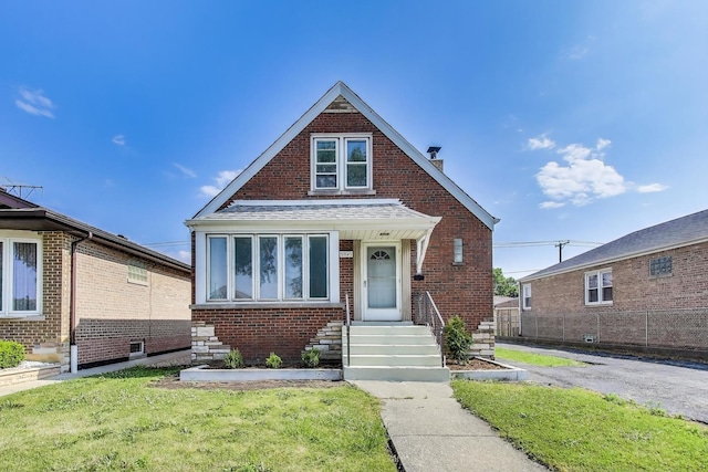 5949 W 55th St, Chicago, IL 60638 - bungalow featuring brick siding, a chimney, and a front lawn