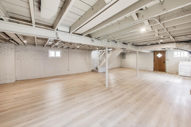 5949 W 55th St, Chicago, IL 60638 - below grade area featuring washer / dryer, healthy amount of natural light, stairway, and wood finished floors