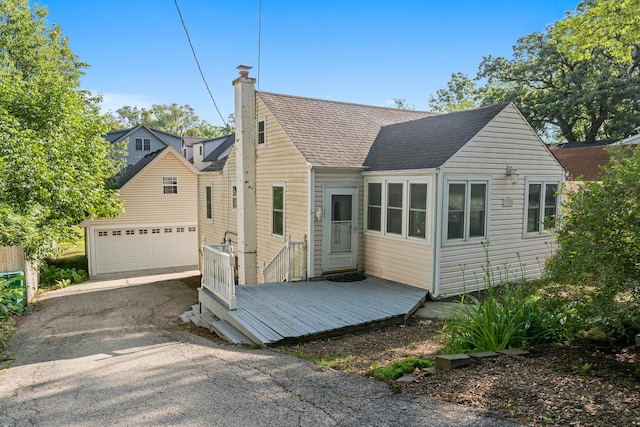 21276 W Arbor Ln, Lake Zurich, IL 60047 - back of property featuring a garage, roof with shingles, driveway, a deck, and a chimney