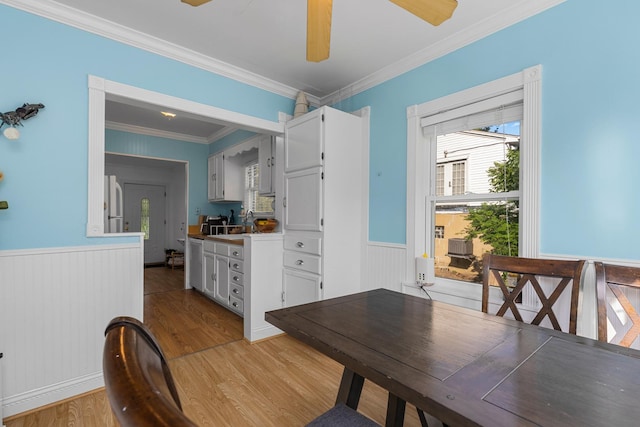 21276 W Arbor Ln, Lake Zurich, IL 60047 - dining area featuring light wood-type flooring, a wainscoted wall, ornamental molding, and a ceiling fan