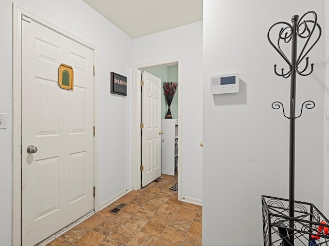 6079 Delaney Dr, Hoffman Estates, IL 60192 - hallway featuring stone finish flooring and baseboards