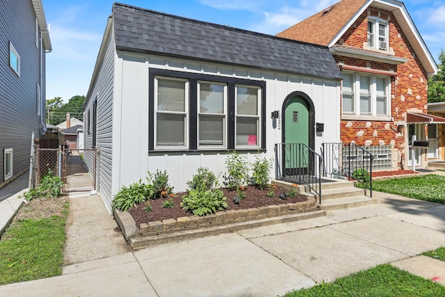 1332 Euclid Ave, Berwyn, IL 60402 - view of front of house with board and batten siding, a gate, and a shingled roof