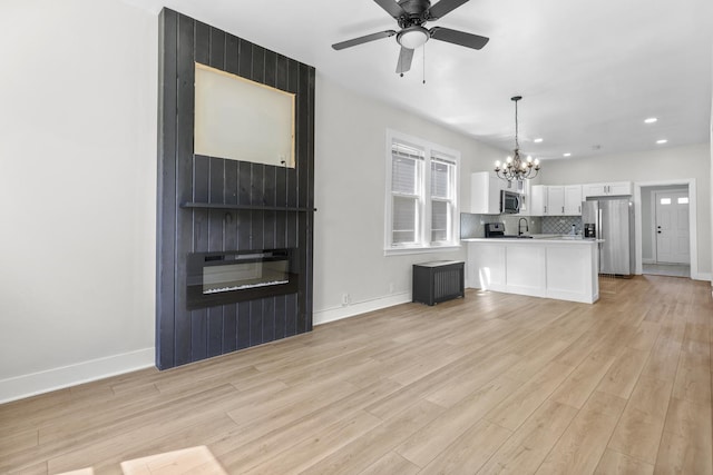 1332 Euclid Ave, Berwyn, IL 60402 - unfurnished living room featuring a chandelier, light wood-style floors, recessed lighting, and ceiling fan