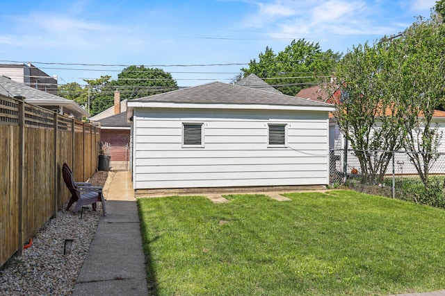 1332 Euclid Ave, Berwyn, IL 60402 - view of property exterior featuring a fenced backyard, a shingled roof, and an outbuilding