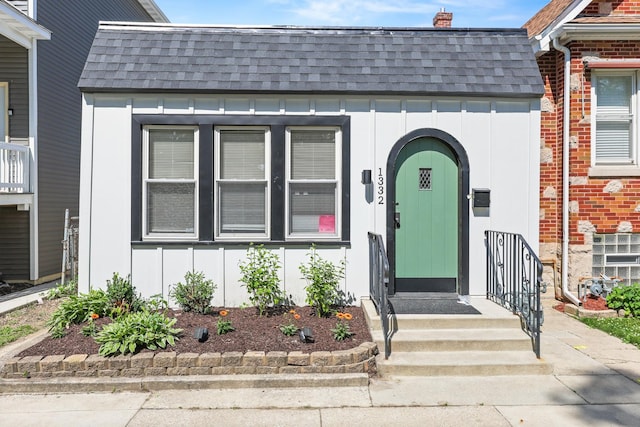 1332 Euclid Ave, Berwyn, IL 60402 - view of exterior entry with board and batten siding, roof with shingles, and brick siding