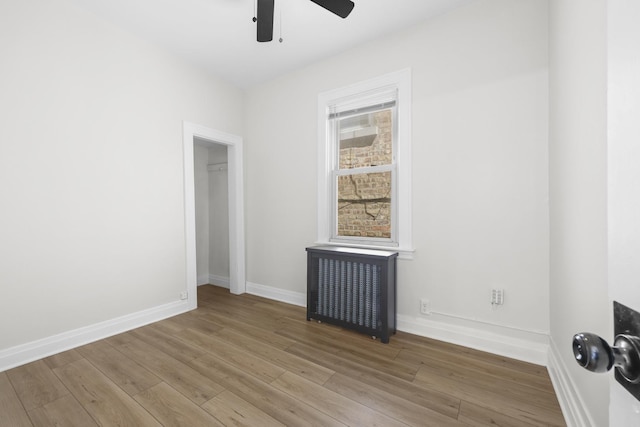 1332 Euclid Ave, Berwyn, IL 60402 - spare room with radiator heating unit, wood finished floors, and a ceiling fan