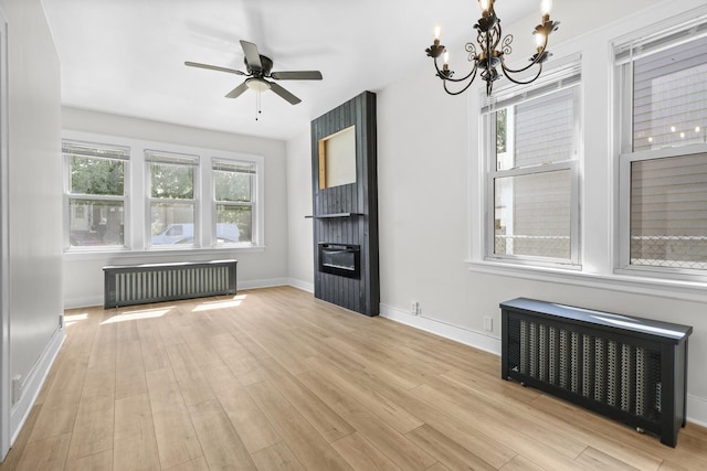 1332 Euclid Ave, Berwyn, IL 60402 - unfurnished living room featuring radiator, radiator heating unit, a chandelier, wood finished floors, and ceiling fan
