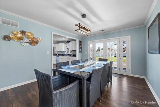 1425 N River Rd, Mchenry, IL 60051 - dining room featuring french doors, crown molding, dark wood-style floors, and a chandelier