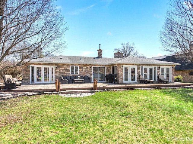 1425 N River Rd, Mchenry, IL 60051 - rear view of property featuring french doors, an outdoor hangout area, a wooden deck, a lawn, and stone siding
