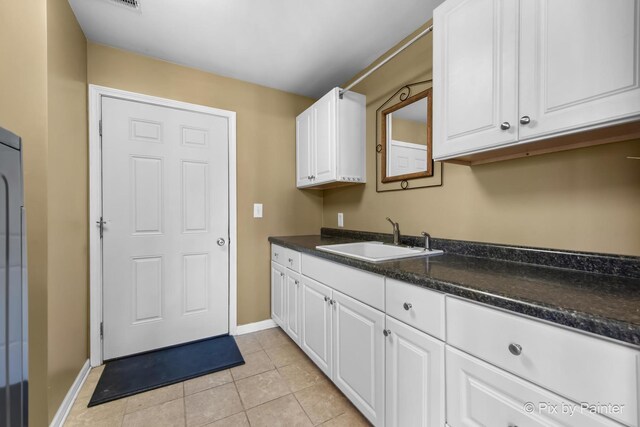 1425 N River Rd, Mchenry, IL 60051 - laundry area featuring a sink and light tile patterned flooring
