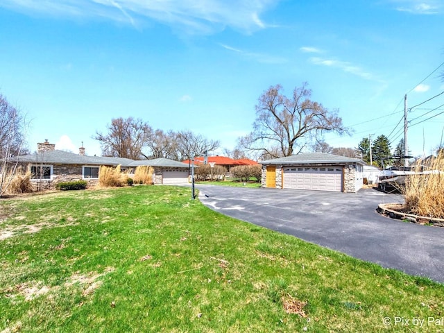 1425 N River Rd, Mchenry, IL 60051 - view of front of house with stone siding, a garage, a front yard, and a chimney