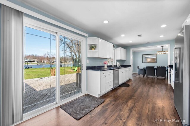 1425 N River Rd, Mchenry, IL 60051 - kitchen with appliances with stainless steel finishes, a water view, dark countertops, white cabinetry, and open shelves