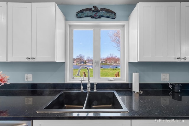 1425 N River Rd, Mchenry, IL 60051 - kitchen with white cabinetry, dark stone counters, and dishwashing machine