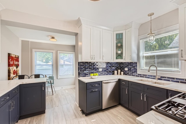 1726 W 106th St, Chicago, IL 60643 - kitchen with stainless steel dishwasher, white cabinets, light stone countertops, backsplash, and decorative light fixtures