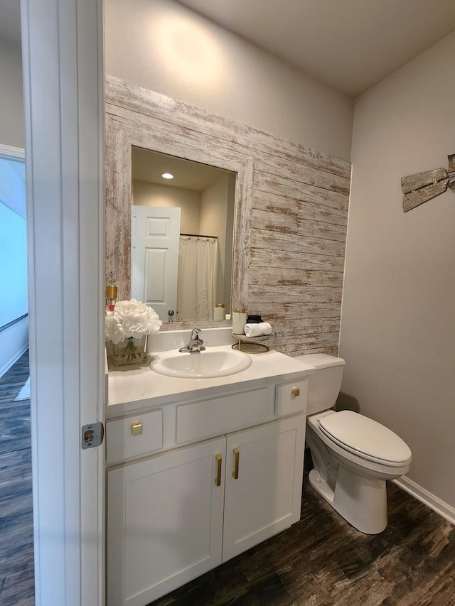 12549 New York St, Loves Park, IL 61111 - bathroom with vanity, wooden walls, and wood finished floors