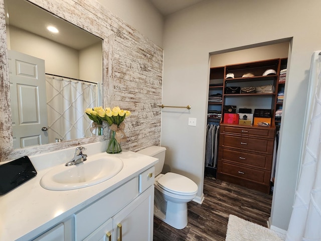 12549 New York St, Loves Park, IL 61111 - bathroom with vanity, wood finished floors, and a walk in closet