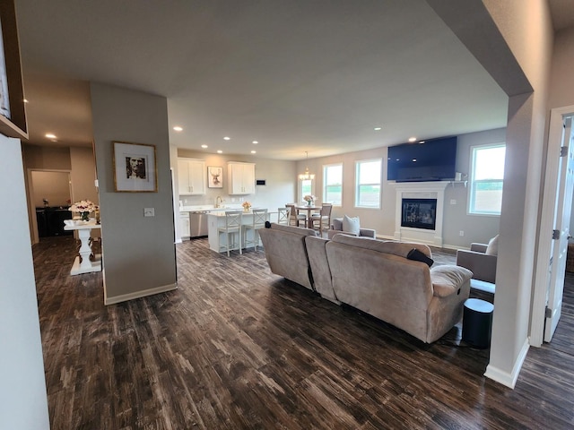12549 New York St, Loves Park, IL 61111 - living room with dark wood-style flooring, recessed lighting, and a glass covered fireplace