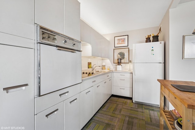 3900 N Lake Shore Dr Unit 7C, Chicago, IL 60613 - kitchen featuring white appliances, white cabinets, and light countertops