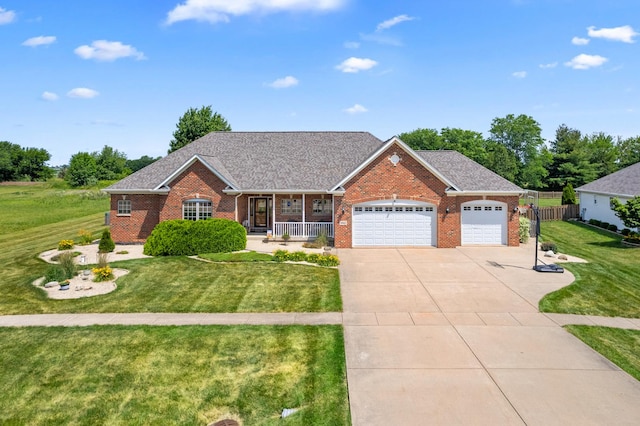990 Fox Trail Ln, Somonauk, IL 60552 - view of front facade featuring brick siding, covered porch, a garage, driveway, and roof with shingles