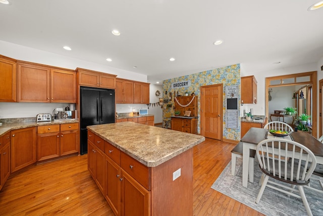990 Fox Trail Ln, Somonauk, IL 60552 - kitchen featuring freestanding refrigerator, a kitchen island, light wood-style flooring, brown cabinets, and recessed lighting