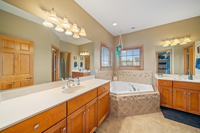 990 Fox Trail Ln, Somonauk, IL 60552 - bathroom with tile patterned floors, a bath, two vanities, and a stall shower