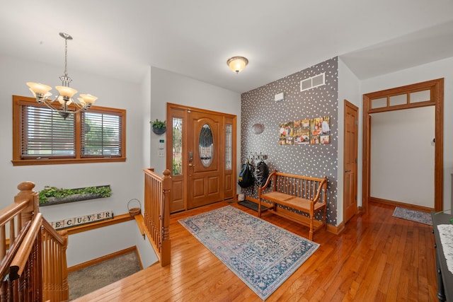 990 Fox Trail Ln, Somonauk, IL 60552 - foyer with a chandelier, wood-type flooring, an accent wall, and wallpapered walls