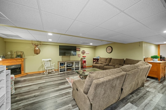 990 Fox Trail Ln, Somonauk, IL 60552 - living room featuring a glass covered fireplace, wood finished floors, a drop ceiling, and recessed lighting