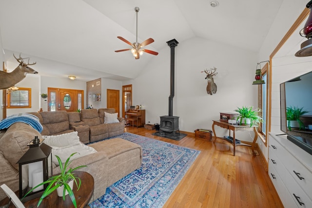 990 Fox Trail Ln, Somonauk, IL 60552 - living room with a wood stove, vaulted ceiling, a ceiling fan, and light wood finished floors