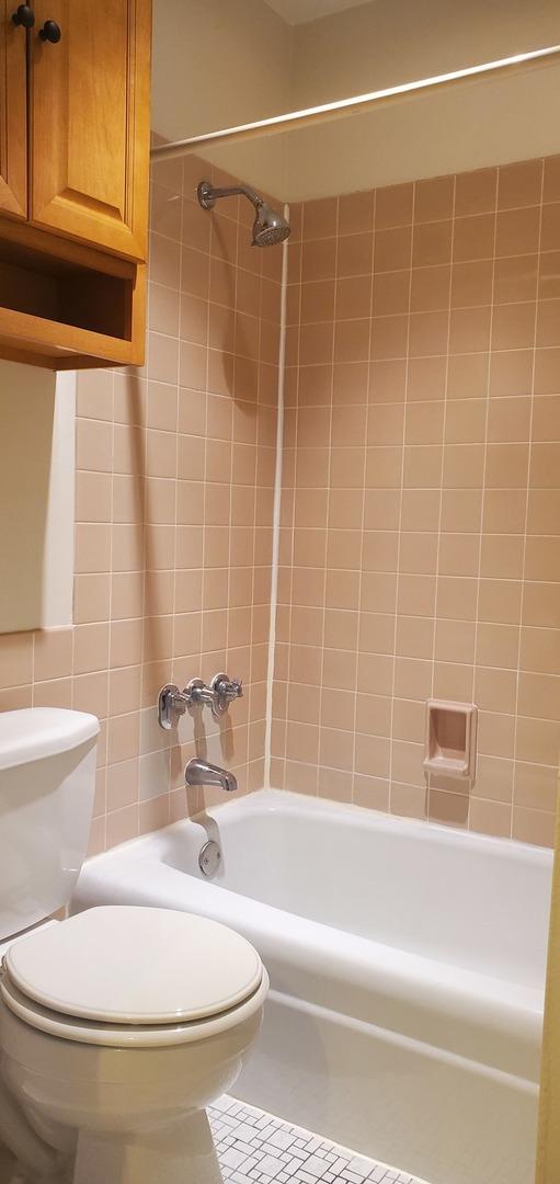 5100 Carriageway Dr Unit 305-2, Rolling Meadows, IL 60008 - bathroom with shower / tub combination, tile patterned flooring, and tile walls