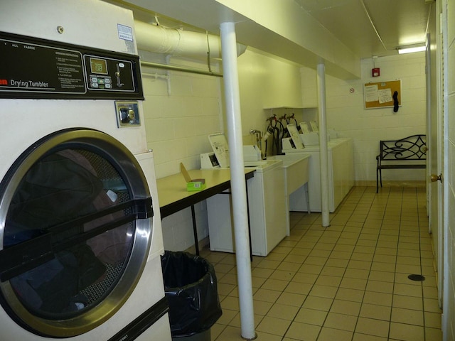 5100 Carriageway Dr Unit 305-2, Rolling Meadows, IL 60008 - laundry room featuring separate washer and dryer, concrete block wall, and light tile patterned floors