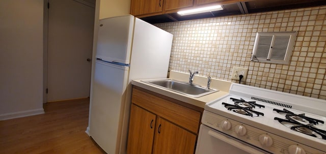 5100 Carriageway Dr Unit 305-2, Rolling Meadows, IL 60008 - kitchen featuring white appliances, light countertops, light wood finished floors, and brown cabinets