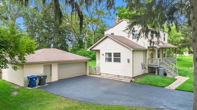 3304 W 160th St, Markham, IL 60428 - view of front of home with an outdoor structure, a garage, a chimney, covered porch, and a front yard