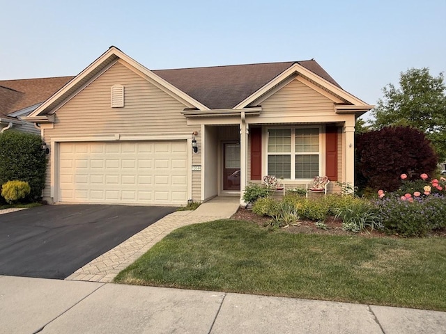 13044 Redstone Dr, Huntley, IL 60142 - ranch-style home with asphalt driveway, an attached garage, a front yard, and roof with shingles