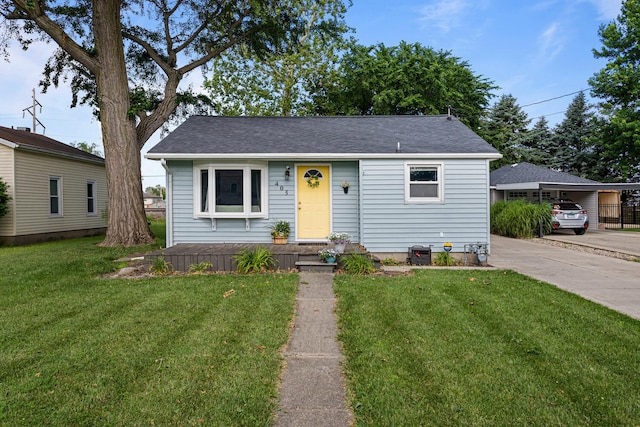 405 N Vorcey St, Tolono, IL 61880 - bungalow-style house with a carport, a front yard, and driveway